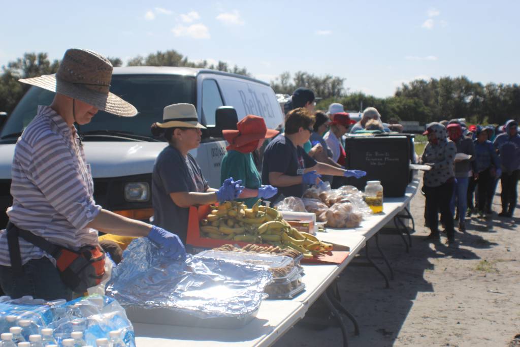 Volunteers serve food at an outdoor community event