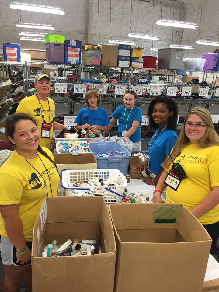 Volunteers sorting donated supplies in a warehouse
